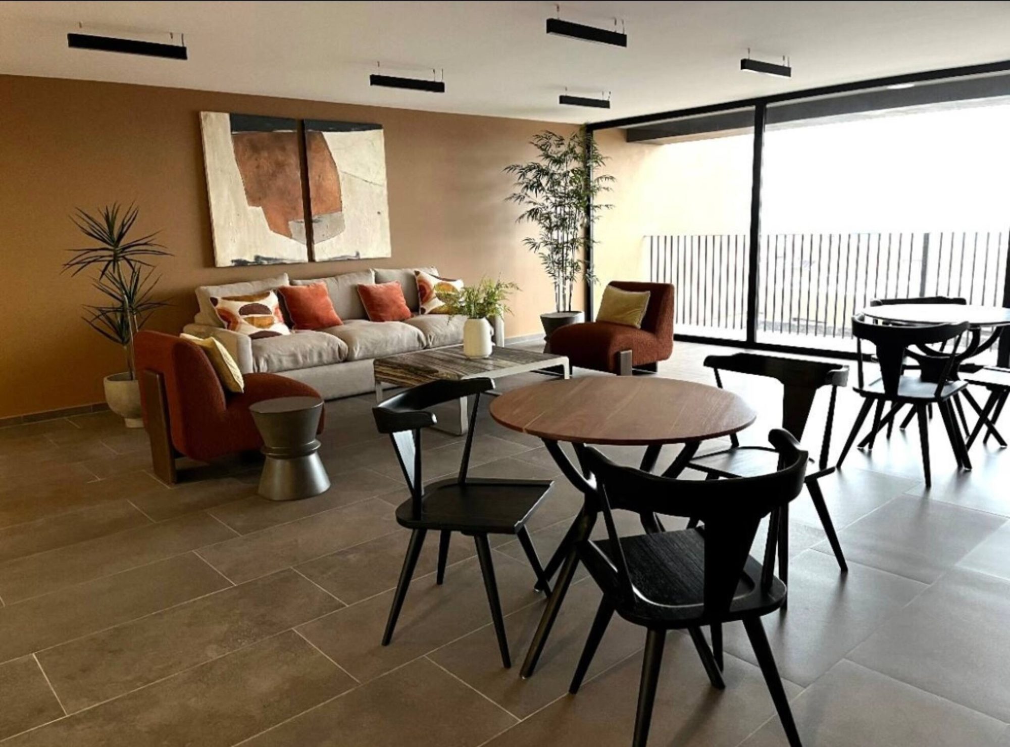 Living and dining room of Unit 612, with floor-to-ceiling windows and a private terrace